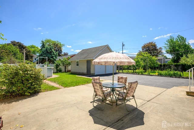 1909 Hamilton Blvd, South Plainfield, NJ 07080 - view of patio featuring a garage, an outdoor structure, driveway, and outdoor dining area