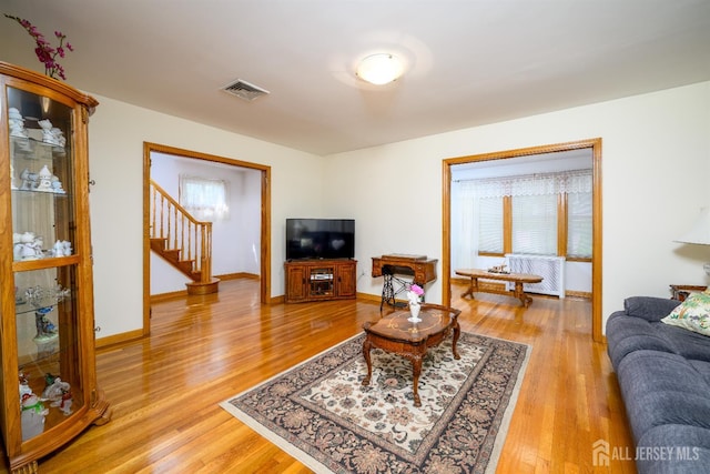 1909 Hamilton Blvd, South Plainfield, NJ 07080 - living area featuring light wood-style flooring, stairs, and baseboards