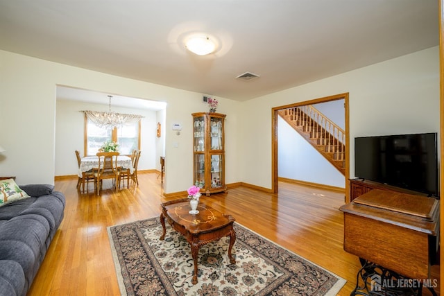 1909 Hamilton Blvd, South Plainfield, NJ 07080 - living room featuring light wood finished floors, a chandelier, stairway, and baseboards