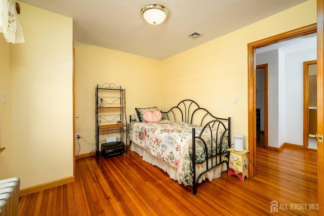 1909 Hamilton Blvd, South Plainfield, NJ 07080 - bedroom featuring radiator, wood finished floors, and baseboards