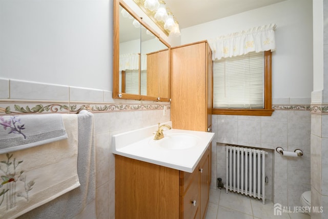 1909 Hamilton Blvd, South Plainfield, NJ 07080 - bathroom with radiator, tile walls, vanity, tile patterned flooring, and toilet