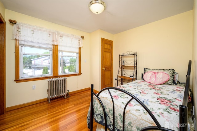 1909 Hamilton Blvd, South Plainfield, NJ 07080 - bedroom with radiator, light wood-style flooring, and baseboards