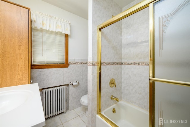 1909 Hamilton Blvd, South Plainfield, NJ 07080 - bathroom with radiator, tile walls, tile patterned floors, combined bath / shower with glass door, and toilet
