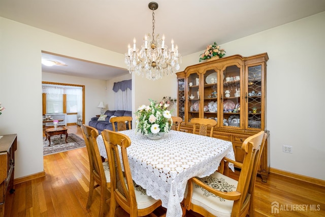 1909 Hamilton Blvd, South Plainfield, NJ 07080 - dining room featuring a chandelier, light wood finished floors, and baseboards