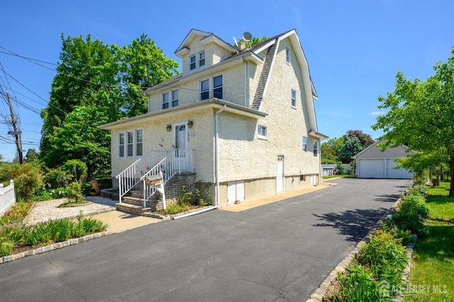 1909 Hamilton Blvd, South Plainfield, NJ 07080 - traditional style home with an outbuilding, a garage, and stucco siding