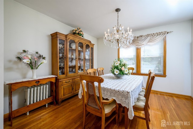 1909 Hamilton Blvd, South Plainfield, NJ 07080 - dining area with radiator heating unit, a chandelier, light wood finished floors, and baseboards