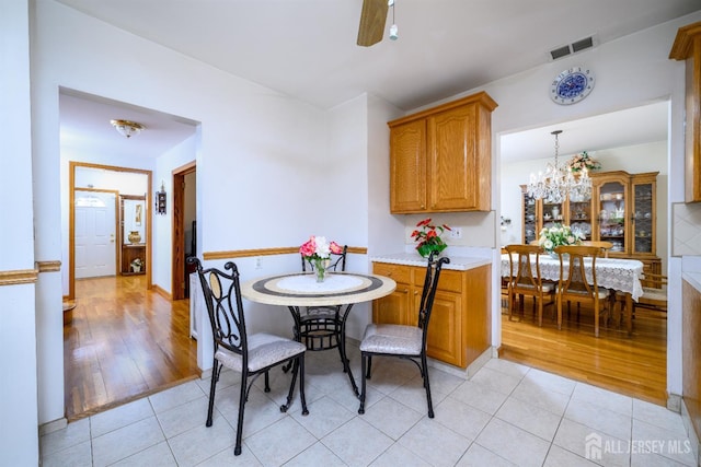 1909 Hamilton Blvd, South Plainfield, NJ 07080 - dining room featuring light tile patterned floors, a chandelier, and a ceiling fan