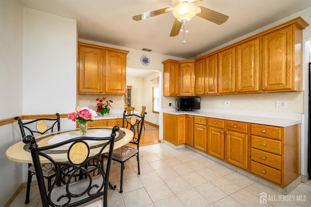 1909 Hamilton Blvd, South Plainfield, NJ 07080 - kitchen featuring decorative backsplash, light countertops, and brown cabinets