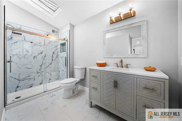 bathroom with toilet, vanity, lofted ceiling with skylight, and walk in shower