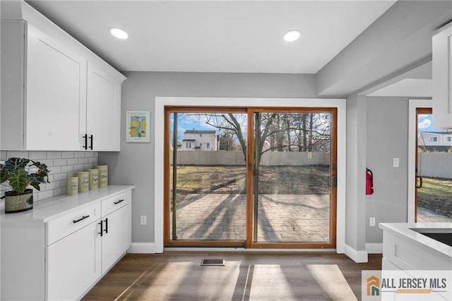 doorway to outside with dark hardwood / wood-style flooring