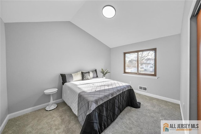 bedroom with carpet flooring and lofted ceiling