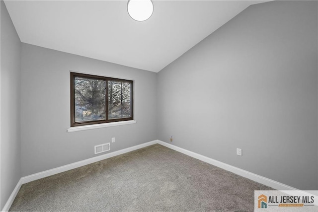 unfurnished room with carpet and lofted ceiling