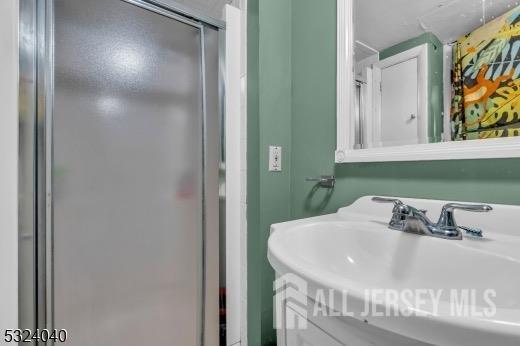 27 6th Ave, Port Reading, NJ 07064 - bathroom featuring a shower stall and vanity