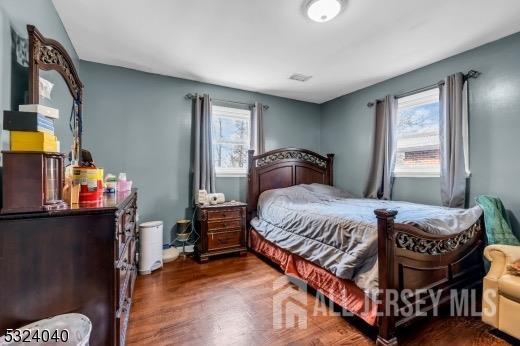 27 6th Ave, Port Reading, NJ 07064 - bedroom featuring wood finished floors and multiple windows