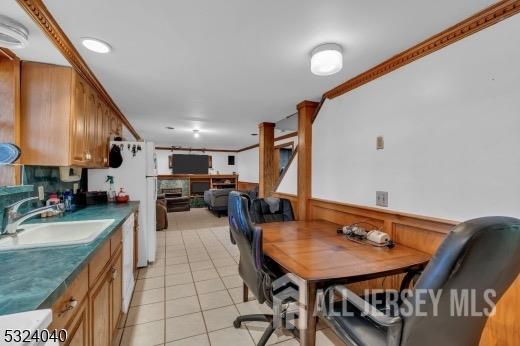 27 6th Ave, Port Reading, NJ 07064 - dining space featuring light tile patterned floors and wainscoting
