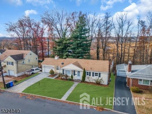 27 6th Ave, Port Reading, NJ 07064 - view of front facade with a garage, a front lawn, and concrete driveway