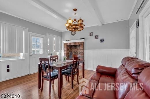 27 6th Ave, Port Reading, NJ 07064 - dining space featuring a chandelier, wood finished floors, and wainscoting