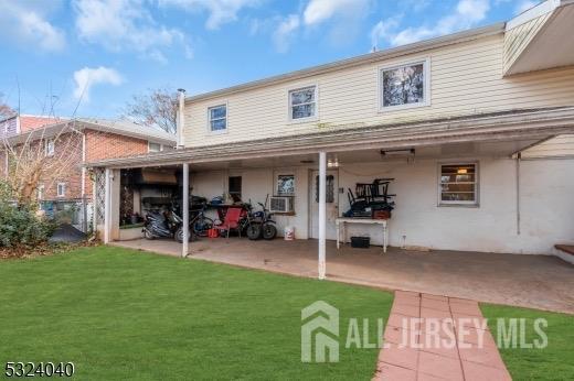 27 6th Ave, Port Reading, NJ 07064 - rear view of house with a patio area and a yard