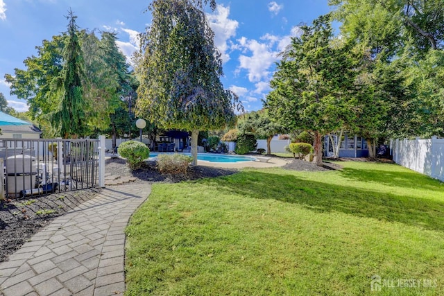 view of yard featuring a fenced in pool and fence