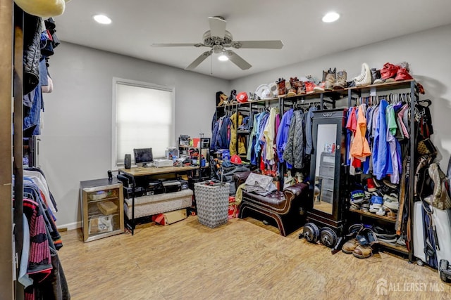 walk in closet with ceiling fan and wood finished floors