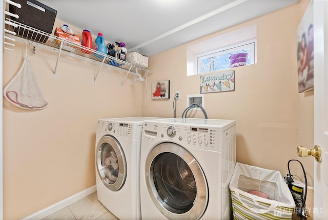 laundry room with baseboards, tile patterned flooring, laundry area, and independent washer and dryer