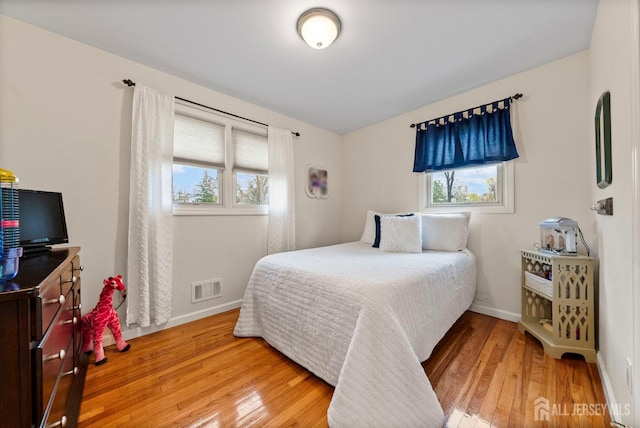 bedroom featuring visible vents, baseboards, and light wood-type flooring