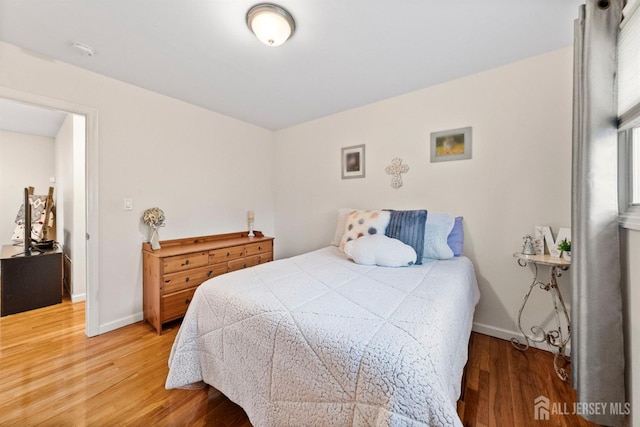 bedroom featuring baseboards and light wood-type flooring