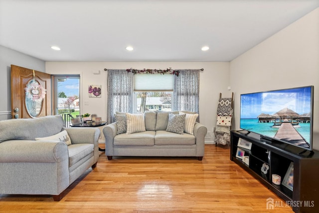 living area featuring recessed lighting, light wood-style flooring, and a wealth of natural light