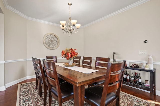 dining room with ornamental molding, a notable chandelier, and dark hardwood / wood-style flooring