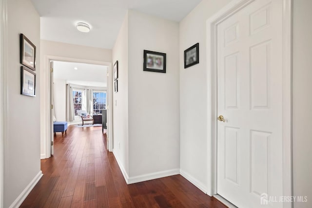 corridor with dark wood-type flooring