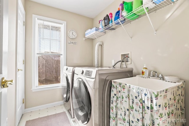 washroom with washer and dryer and a healthy amount of sunlight