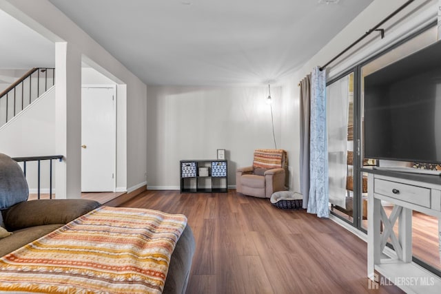 bedroom with baseboards and wood finished floors