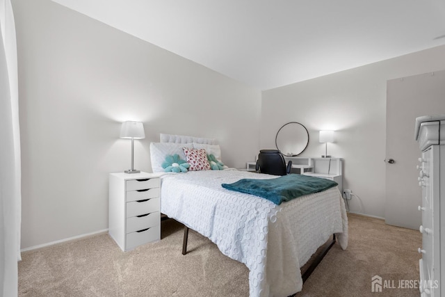 bedroom featuring light carpet