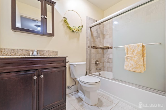 full bathroom featuring enclosed tub / shower combo, vanity, toilet, and tile patterned floors