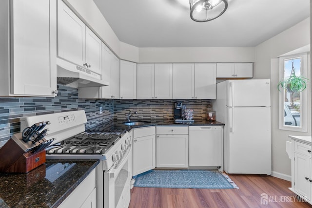 kitchen with white cabinetry, a sink, wood finished floors, white appliances, and under cabinet range hood