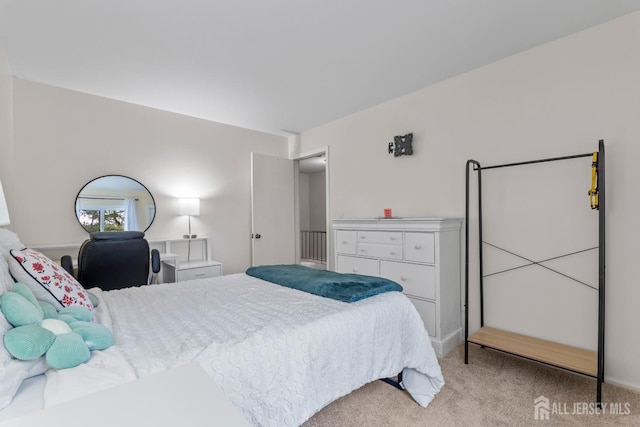 bedroom featuring light colored carpet