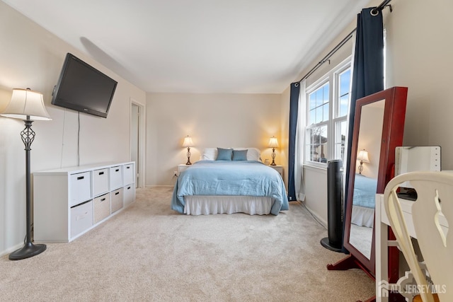 carpeted bedroom featuring baseboards