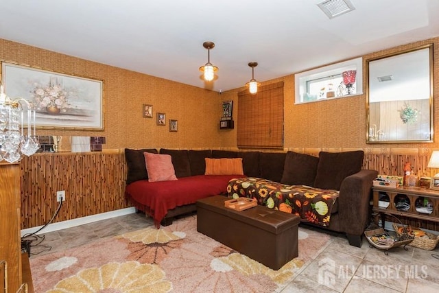 living area with wallpapered walls and visible vents