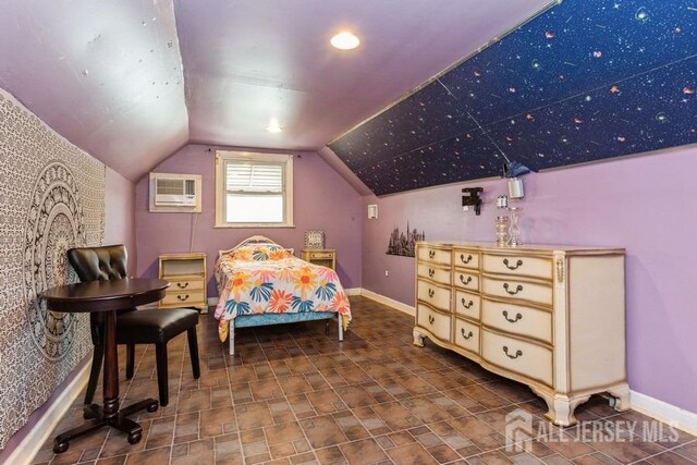 bedroom with a wall mounted AC, baseboards, and lofted ceiling