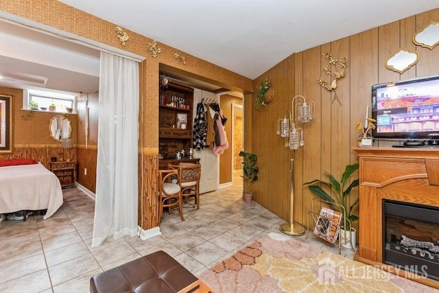 interior space featuring wood walls and light tile patterned floors