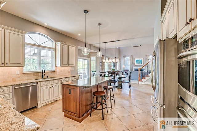 4 Van Gogh Ct, South Brunswick, NJ 08852 - kitchen with stainless steel appliances, a sink, cream cabinets, light stone countertops, and recessed lighting