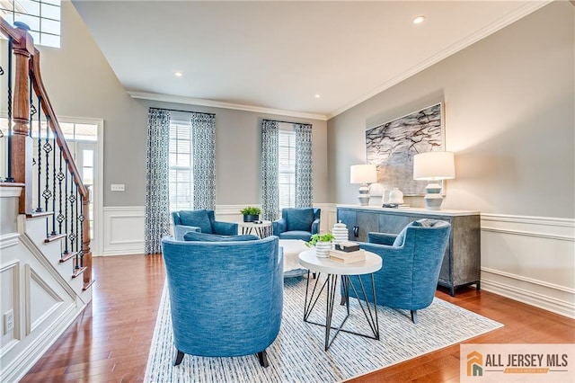 4 Van Gogh Ct, South Brunswick, NJ 08852 - living room featuring wood finished floors, crown molding, wainscoting, a decorative wall, and stairs