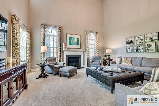 4 Van Gogh Ct, South Brunswick, NJ 08852 - carpeted living room with a towering ceiling, a fireplace with flush hearth, and baseboards