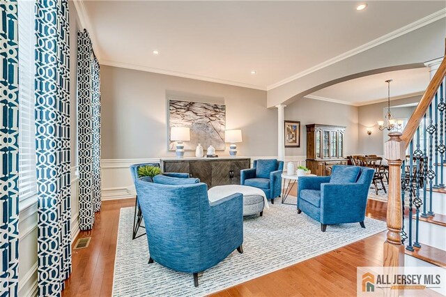 4 Van Gogh Ct, South Brunswick, NJ 08852 - living room featuring arched walkways, wainscoting, wood finished floors, recessed lighting, and decorative columns