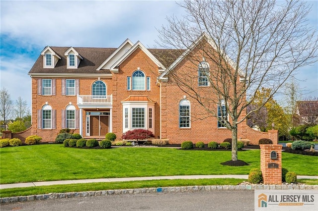 4 Van Gogh Ct, South Brunswick, NJ 08852 - colonial house featuring a front yard and brick siding