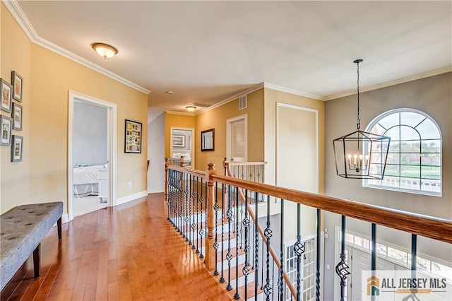 4 Van Gogh Ct, South Brunswick, NJ 08852 - corridor with a chandelier, an upstairs landing, wood-type flooring, crown molding, and baseboards
