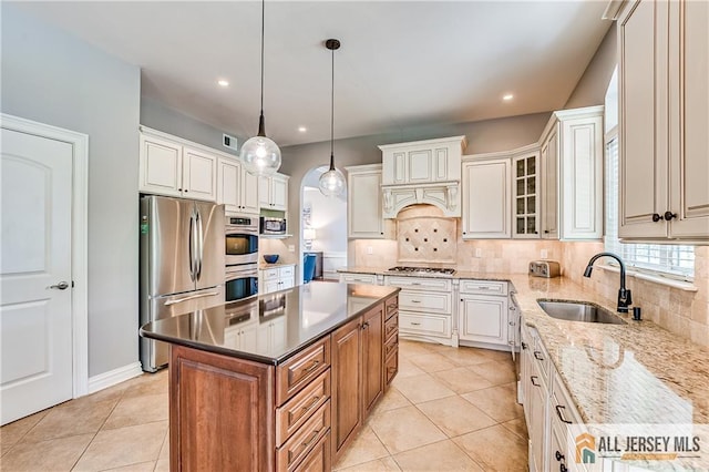4 Van Gogh Ct, South Brunswick, NJ 08852 - kitchen with stainless steel appliances, a sink, decorative backsplash, light tile patterned floors, and pendant lighting