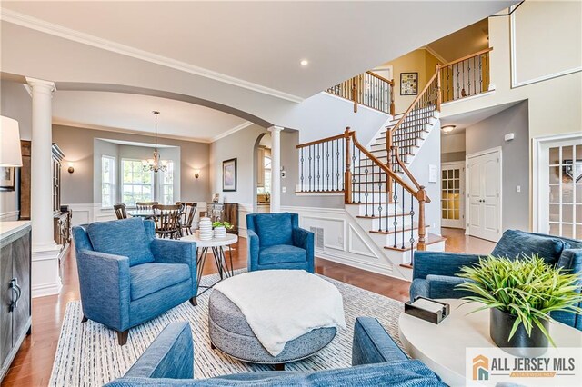 4 Van Gogh Ct, South Brunswick, NJ 08852 - living area with decorative columns, wood finished floors, arched walkways, ornamental molding, and stairway