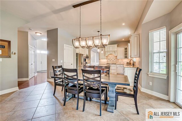 4 Van Gogh Ct, South Brunswick, NJ 08852 - dining area with lofted ceiling, baseboards, light tile patterned flooring, a chandelier, and recessed lighting