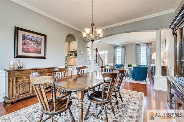 4 Van Gogh Ct, South Brunswick, NJ 08852 - dining area with arched walkways, dark wood-type flooring, decorative columns, ornamental molding, and stairway
